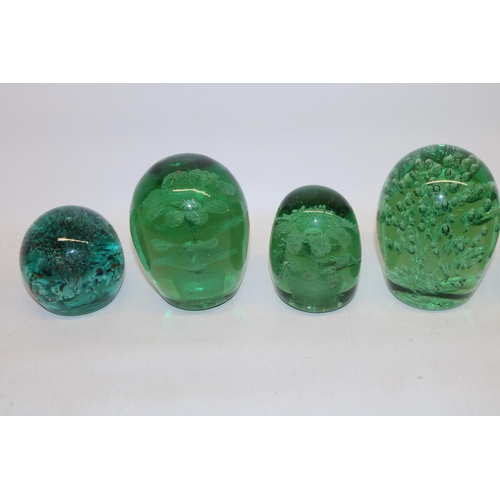 417 - Group of seven green glass dumps, four with internal flowers, max H13cm.