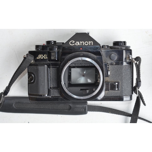 703 - Collection of 35mm SLR cameras and accessories to include Canon A-1 with Canon 28mm and 50mm lenses,... 