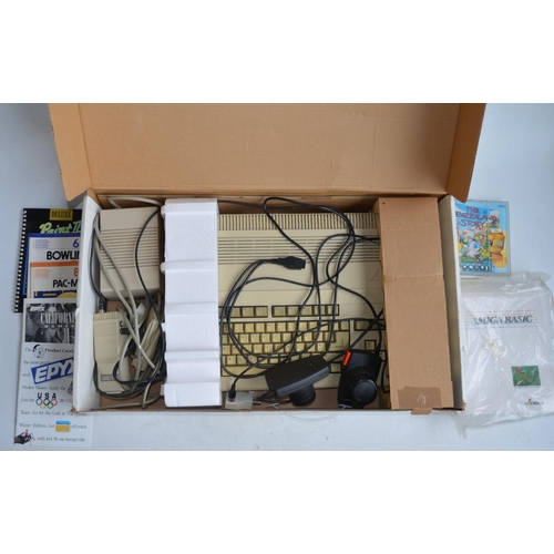 708 - Boxed Commodore Amiga Model 500, an Atari Video Computer System (controllers and game instructions b... 