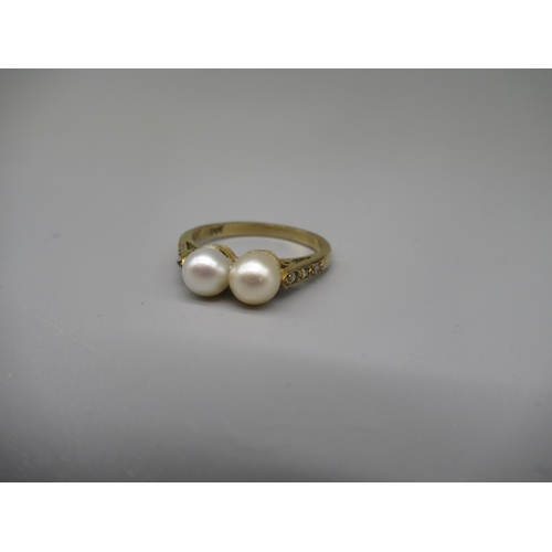 608 - 9ct yellow metal ring set with two pearls on diamond set shoulders, stamped 9ct, size N, 2.5g