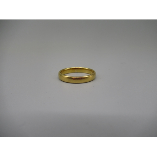 609 - 22ct yellow gold wedding band, stamped 22, size N, 3.7g