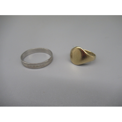 612 - 18ct white gold faceted band ring, stamped 750, size Q1/2, 2.3g, and a 9ct yellow gold signet ring, ... 