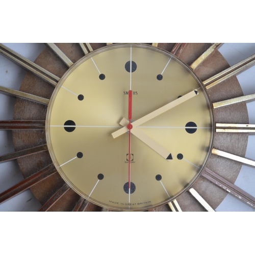 653 - Smiths 1970's battery operated plastic moulded sunburst wall clock, some gold finish rubbed away, so... 