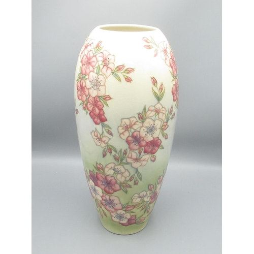 199 - Moorcroft Pottery: Spring Blossom pattern vase, tube lined with pink flowers on graduated green grou... 