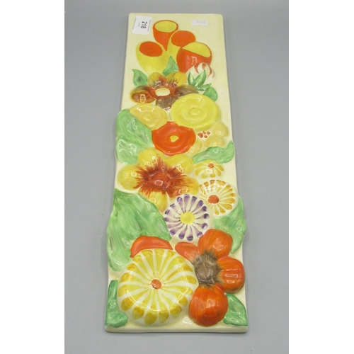 218 - Clarice Cliff rectangular wall plaque, moulded in relief with flowers, 42.5x12cm, Clarice Cliff Wilk... 