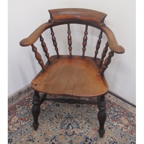 746 - Early C20th smokers bow armchair with stepped back and shaped elm seat on turned supports joined by ... 