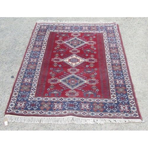 751 - Modern Caucasian rug, triple medallion red field with in repeating striped boarder 168cm x 120cm