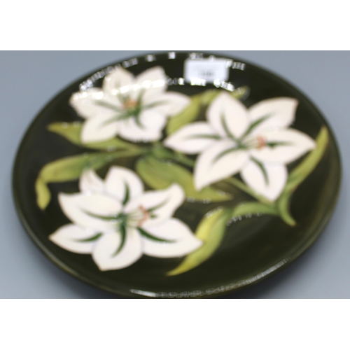 198 - Moorcroft Pottery: Bermuda Lily pattern plate, inscribed to reverse 'The Moorcrofts sold Glendair to... 