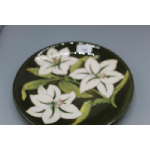 198 - Moorcroft Pottery: Bermuda Lily pattern plate, inscribed to reverse 'The Moorcrofts sold Glendair to... 