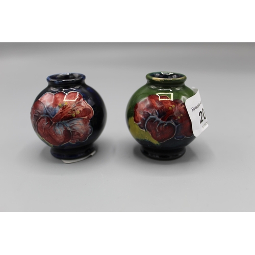 204 - Moorcroft Pottery: two Hibiscus pattern miniature vases, tube lined with purple and yellow flowers o... 