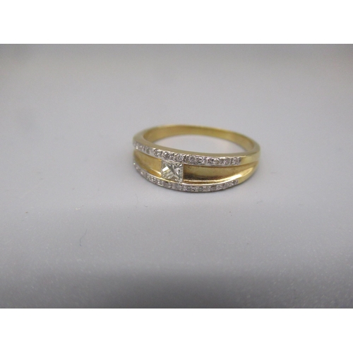 602 - 18ct yellow gold ring set with central square cut diamond, and diamond set edges, stamped K18, size ... 