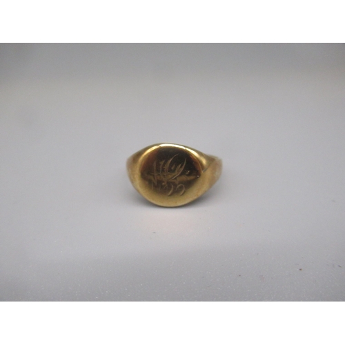 606 - Yellow metal circular signet ring, engraved with initials JW, marks worn, size S, 6.2g