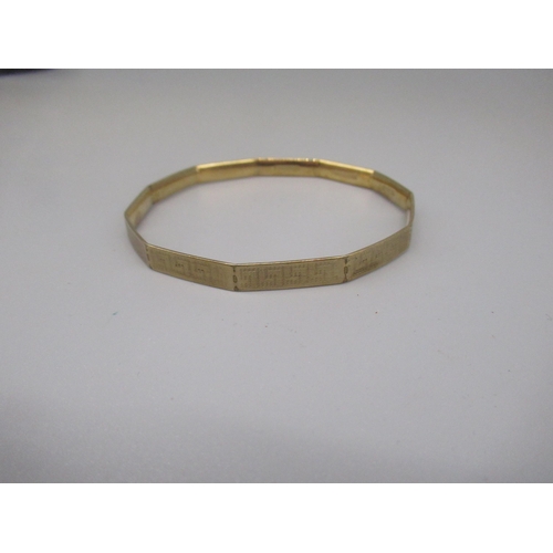 607 - LW&G Lagarmic 9ct gold bronze core bangle, with Greek Key design, stamped 9c