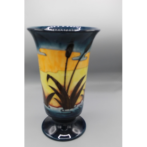 192 - Moorcroft Pottery: Reeds at Sunset pattern footed vase, flared rim, tube lined with water reeds in l... 