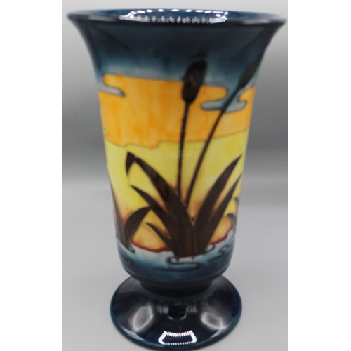 192 - Moorcroft Pottery: Reeds at Sunset pattern footed vase, flared rim, tube lined with water reeds in l... 