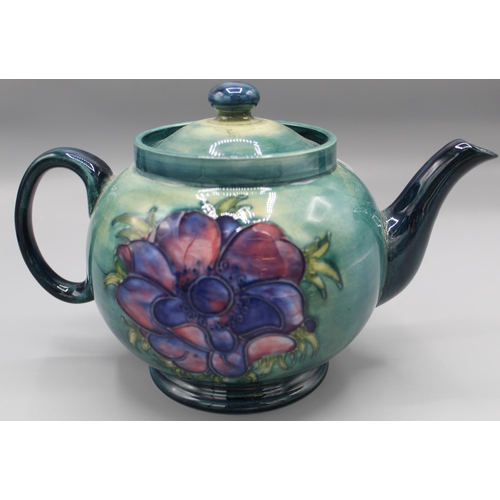 196 - Moorcroft Pottery: Anemone pattern teapot and cover, tube lined with pink flowers on graduated green... 