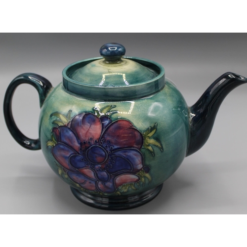 196 - Moorcroft Pottery: Anemone pattern teapot and cover, tube lined with pink flowers on graduated green... 