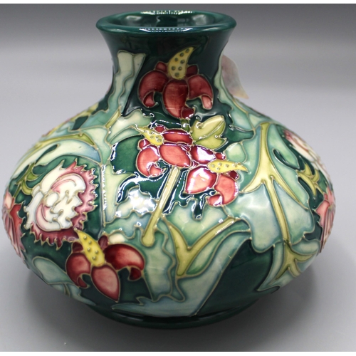 197 - Moorcroft Pottery: Leicester pattern squat vase, tube lined with red and yellow flowers on green gro... 