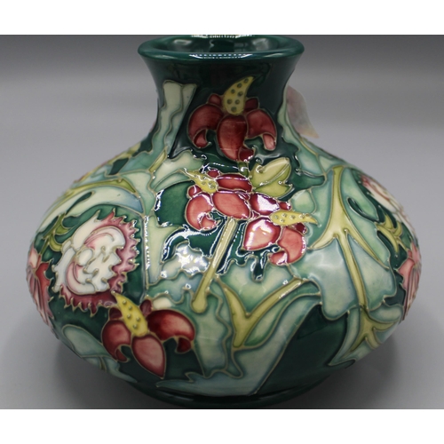 197 - Moorcroft Pottery: Leicester pattern squat vase, tube lined with red and yellow flowers on green gro... 