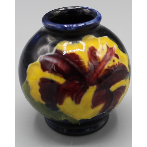 204 - Moorcroft Pottery: two Hibiscus pattern miniature vases, tube lined with purple and yellow flowers o... 