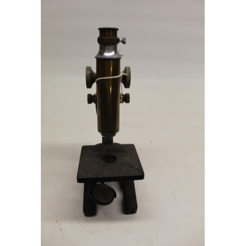 224 - C20th brass and japanned microscope on triform base, no visible maker, H33cm