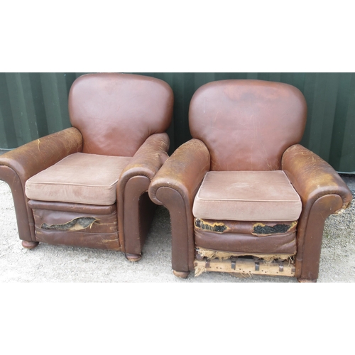 749 - Pair of brown leather upholstered club type armchairs with sprung seats, turned wooden feet and cast... 