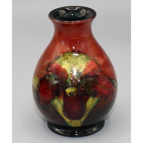 207 - Moorcroft Pottery: Floral pattern flambe vase, tube lined with red and green flowers on red ground, ... 