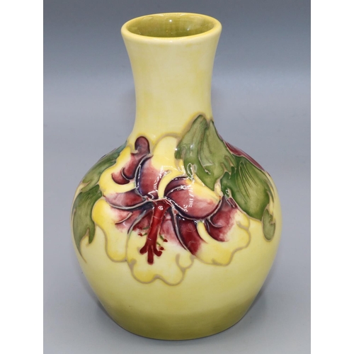 208 - Moorcroft Pottery: Hibiscus pattern baluster vase, tube lined with pink and purple flowers on yellow... 