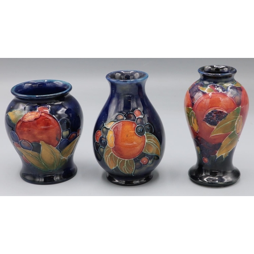 210 - Moorcroft Pottery: Pomegranate pattern vases, H10cm/H9.5cm/H8.5cm (3)