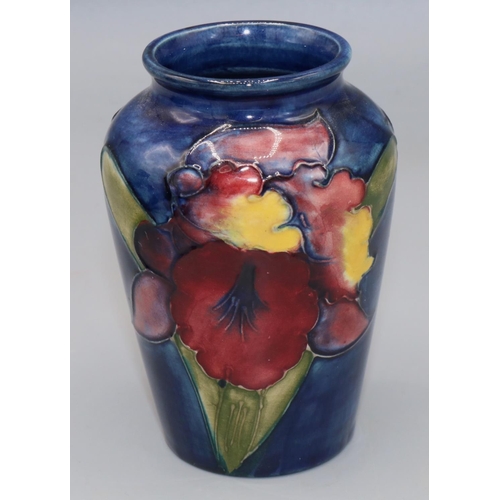 212 - Moorcroft Pottery: Floral pattern baluster vase, tube lined with purple and yellow flowers on dark b... 