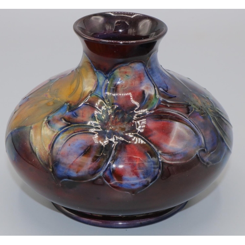 215 - Moorcroft Pottery: Flambe Clematis pattern squat vase, tube lined with purple and red flowers on mar... 