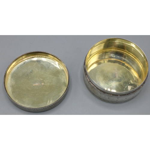 1202 - Continental silver circular pill box, with dot decoration in leaf clasped reeded bands, engine turne... 