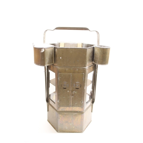 109 - Mid C20th tin travelling camping tiered stove with loop handle and accessories, H70cm