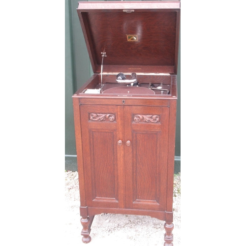 768 - HMV oak cased cabinet gramophone, with two carved and moulded panel doors on vase turned tapering su... 