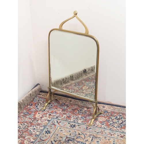 777 - Art Nouveau  brass framed mirrored fire screen, with scrolled handle, and bevel plate on outsplayed ... 