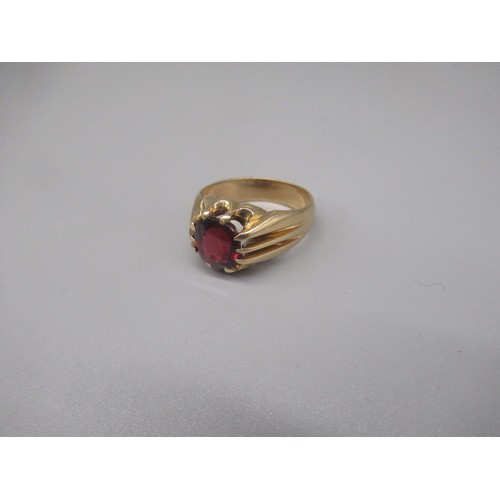 696 - 9ct yellow gold ring set with red glass stone on grooved shoulders, stamped 9ct, size Z+1, 11.2g