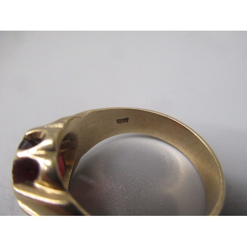 696 - 9ct yellow gold ring set with red glass stone on grooved shoulders, stamped 9ct, size Z+1, 11.2g