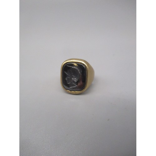 697 - 9ct yellow gold ring set with Roman style intaglio face, stamped 375, size M1/2, 8.2g