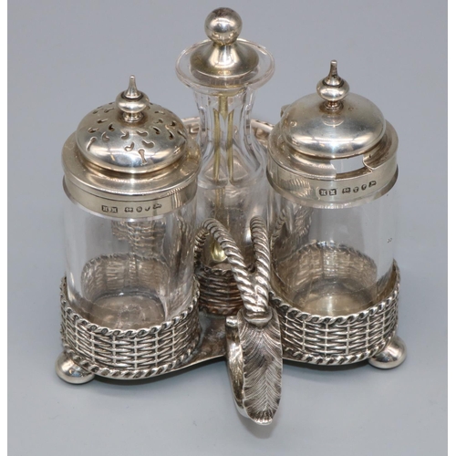 1071 - Victorian hallmarked silver four piece cruet stand, basket weave trefoil base with twist handle on t... 