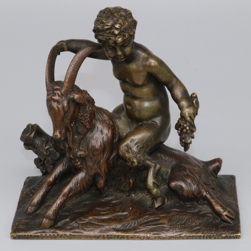 1113 - After the Antique - a small patinated bronze model of a faun with grape bunch astride a goat, on nat... 