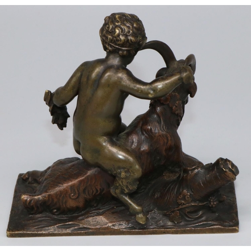 1113 - After the Antique - a small patinated bronze model of a faun with grape bunch astride a goat, on nat... 