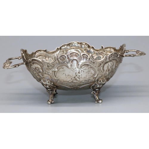 1060 - Late C19th Continental silver two handled oval bon bon dish, repousse with scrolls and buildings, on... 