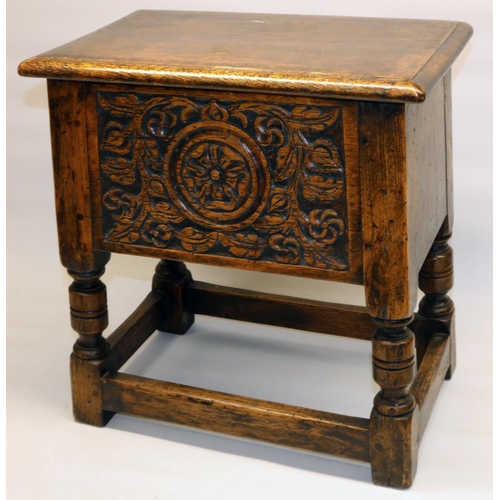 1374 - C17th style oak box stool, front carved with a Yorkshire Rose and leafage, with hinged top on turned... 