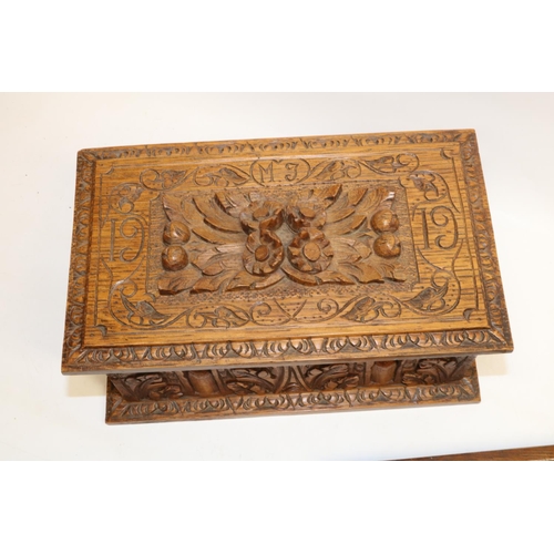 1109 - Early C20th oak box, with arcade and oak leaf carved sides, hinged lid with relief carved floral han... 