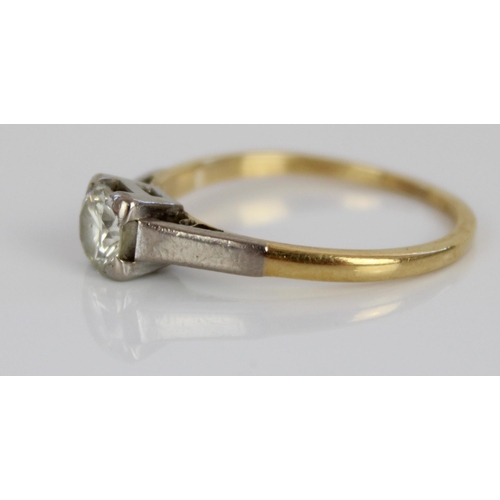 1014 - 18ct yellow and white gold solitaire ring, the round cut diamond in white gold claw setting, on tape... 