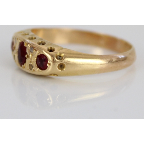 1024 - 18ct yellow ruby and diamond ring, the three rubies and four diamonds in ornate rub-over setting, on... 