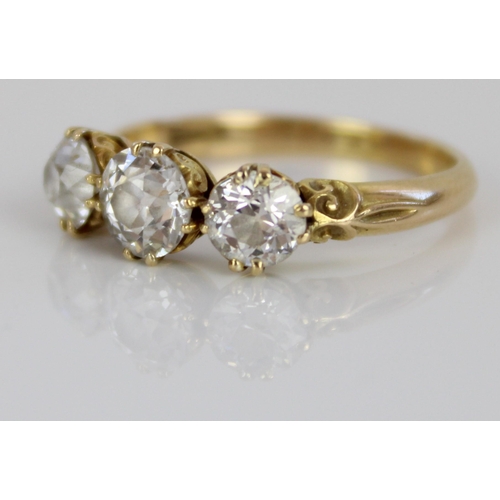 1001 - 18ct yellow gold three stone diamond ring, the central round cut diamond flanked by two smaller roun... 