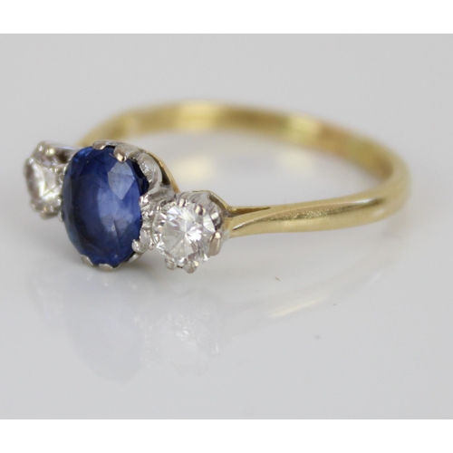 1004 - 18ct yellow gold sapphire and diamond three stone ring, the central oval cut sapphire flanked by two... 