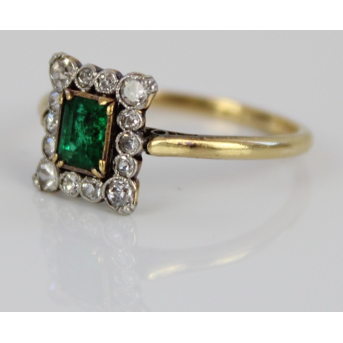 1020 - 18ct yellow gold and platinum cluster ring, the central emerald cut emerald in claw setting, surroun... 