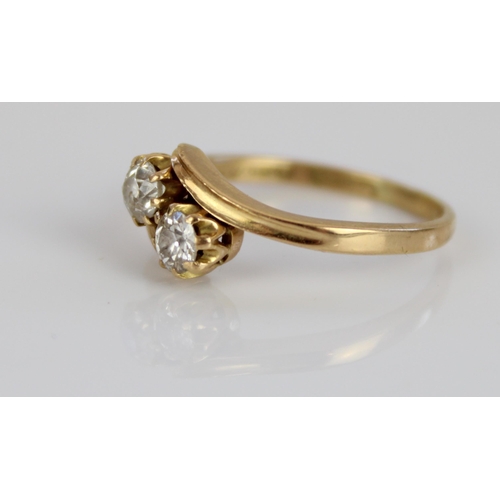 1022 - 18ct yellow gold diamond set crossover ring, the round cut diamonds set in claw settings, on grooved... 